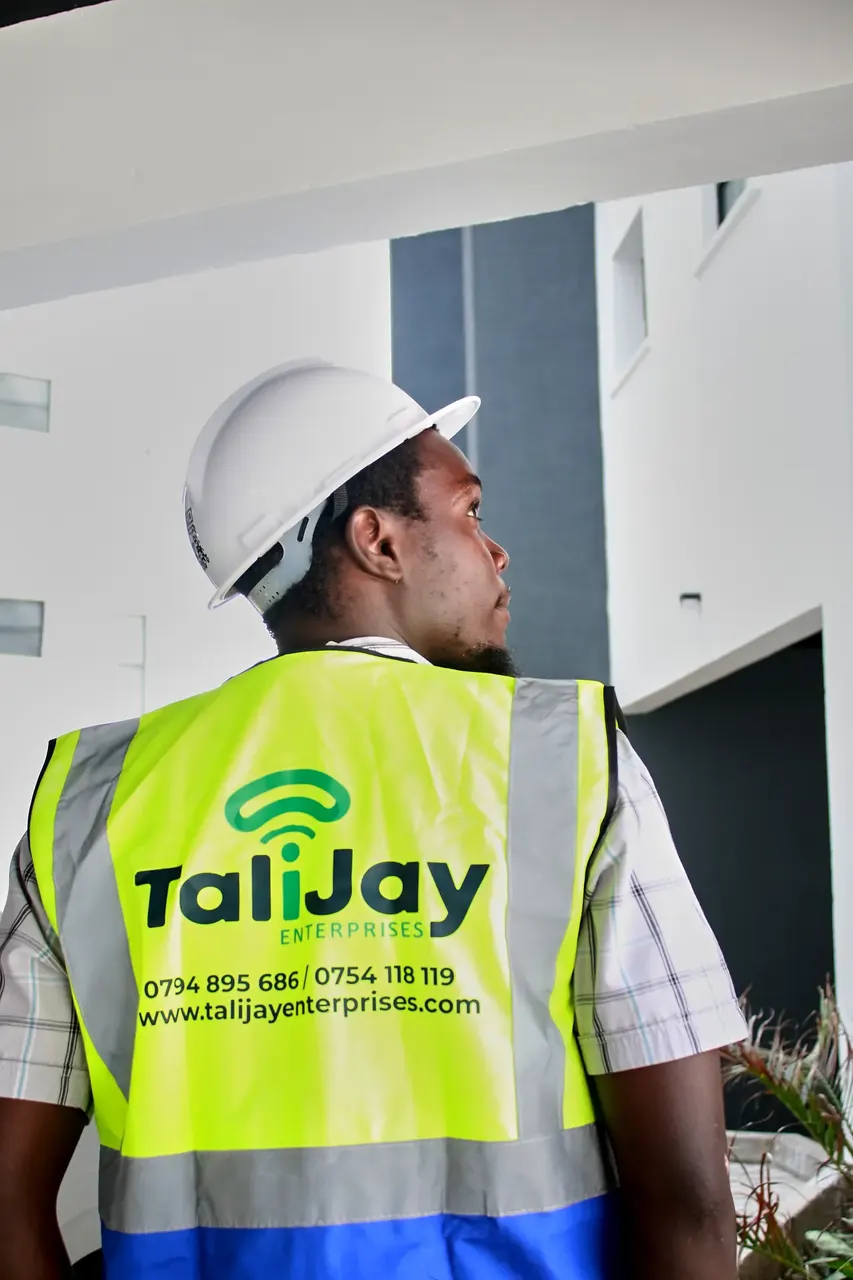Technician in a branded high-visibility vest and hard hat, corporate photoshoot
