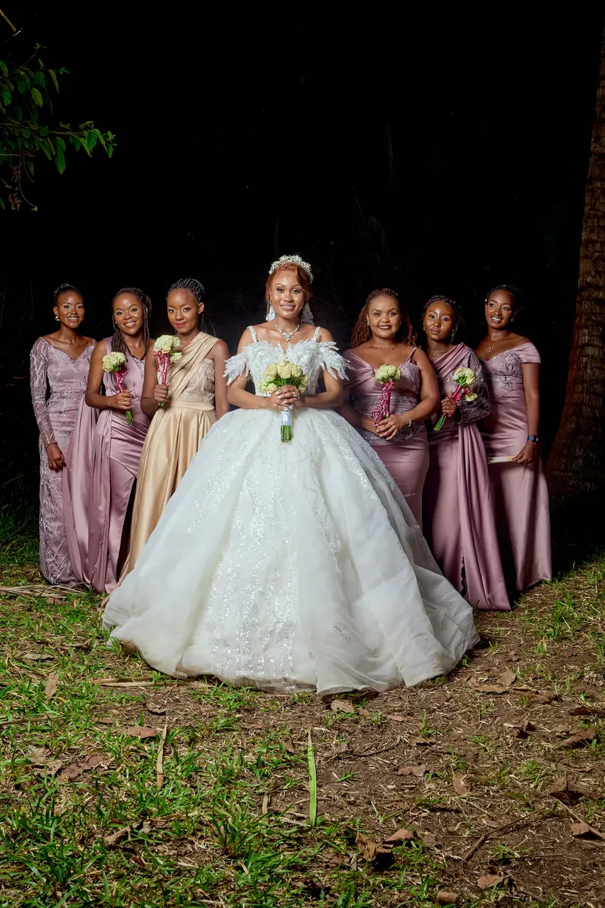 Bride with bouquet in front of her bridesmaids, outdoor wedding photography