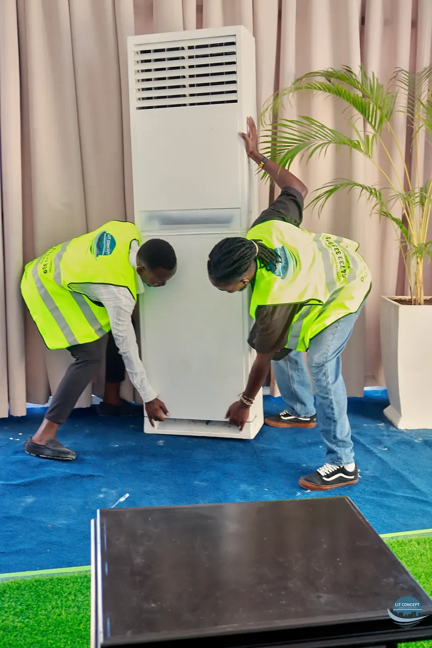 Technicians installing an air-conditioning unit, work-in-progress documentation
